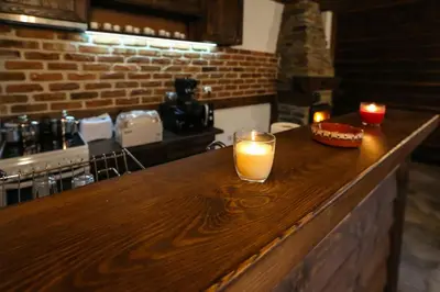 a bar with two candles sitting on top of it at Yancheva Guest House in Delchevo