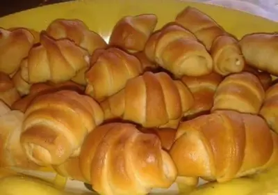 a yellow plate of croissants on a yellow plate at Yancheva Guest House in Delchevo
