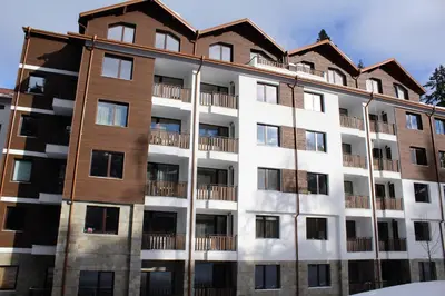 an apartment building with a house on top of it at Borovets Gardens Apartments in Borovets