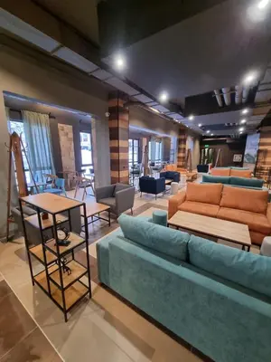 a living room with a blue couch and chairs at Borovets Gardens Apartments in Borovets
