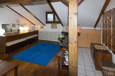 a living room with a blue rug in a attic at Mini Apartment Best Rest in Plovdiv