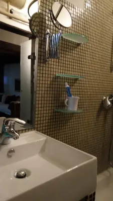 a bathroom with a white sink and a mirror at Mini Apartment Best Rest in Plovdiv