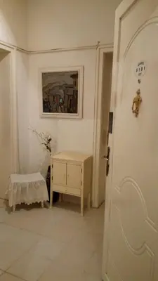 a white room with a table and a door at Maritza Apartment in Plovdiv