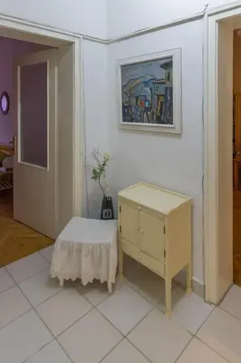 a white room with a table and a cabinet at Maritza Apartment in Plovdiv