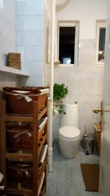 a bathroom with a toilet and a window at Maritza Apartment in Plovdiv