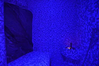 a blue room with a bed and a candle at Art Spa Villa Gal in Velingrad