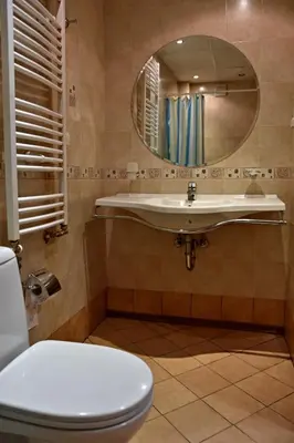 a bathroom with a sink and a toilet and a mirror at Art Spa Villa Gal in Velingrad