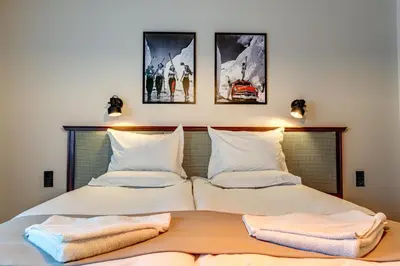 a bedroom with two beds with towels on them at Mountain Lake Hotel in Smolyan