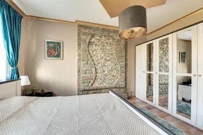 a bedroom with a brick wall and a bed at Unique atmosphere with golden standard design in Sofia