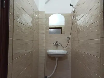 a bathroom with a shower with a sink and a toilet at Guest House Ganovi in Kalofer