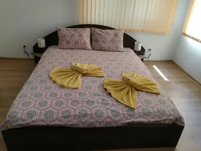 a bed with two bows on top of it at Guest House Ganovi in Kalofer