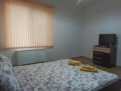 a bedroom with a bed with two towels on it at Guest House Ganovi in Kalofer