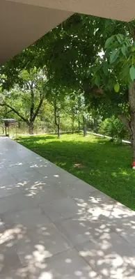 a walkway with a park with a bench and trees at Mihaylova kushta in Lyubosh