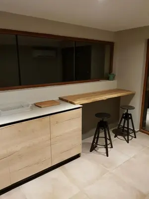 a kitchen with a counter and two bar stools at Mihaylova kushta in Lyubosh