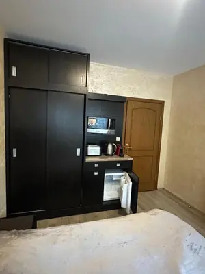 a room with black cabinets and a bed in it at Apartments & Rooms Royal Plaza in Borovets