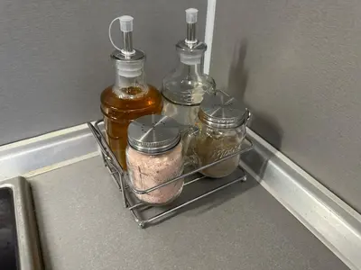 a rack in a refrigerator with jars and condiments at Apartments & Rooms Royal Plaza in Borovets