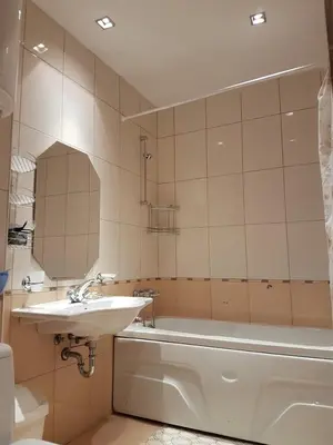 a bathroom with a sink and a tub and a mirror at Lux Studio 45 in Fortuna in Bansko
