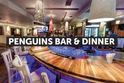a bar with a long wooden counter in a restaurant at Lux Studio 45 in Fortuna in Bansko