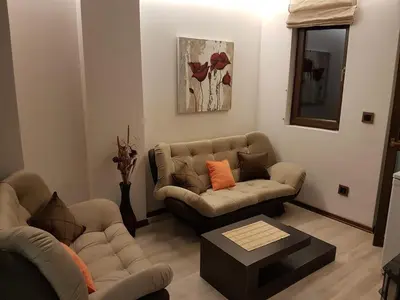 a living room with two couches and a coffee table at Lux Studio 45 in Fortuna in Bansko