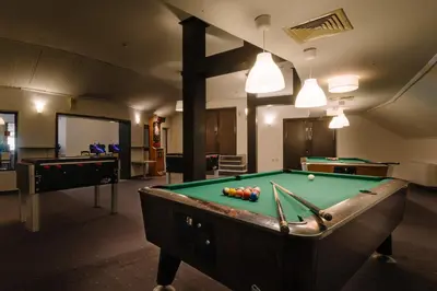 a billiard room with a pool table and two tables at Eco Hotel Zdravetz in Tsar Kaloyan
