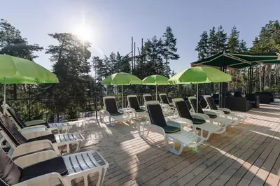 a row of chairs and umbrellas on a deck at Eco Hotel Zdravetz in Tsar Kaloyan