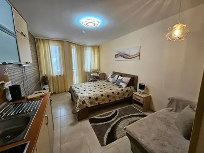 a bedroom with two beds and a sink in it at Enjoy Studios and Lovely Apartment Villa Park in Borovets