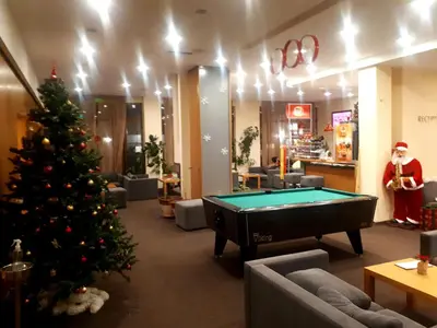 a christmas tree in a room with a pool table at Enjoy Studios and Lovely Apartment Villa Park in Borovets