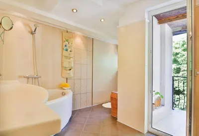 a bathroom with a tub and a toilet and a sink at Portofino Apartment in Sofia