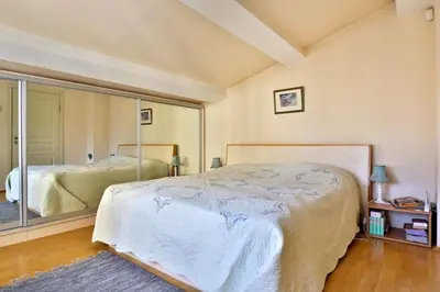 a bedroom with a bed and a large mirror at Portofino Apartment in Sofia