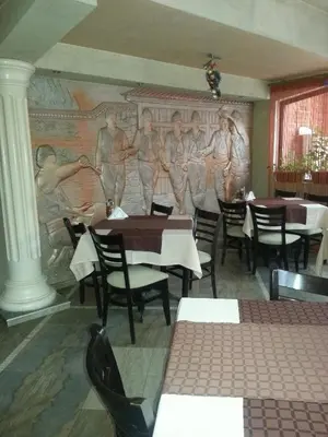 a dining room with a painting on the wall at Family Hotel Yola in Chepelare