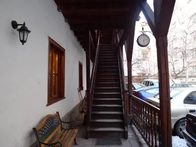 a staircase leading up to a building with a clock at Hostel Mostel Sofia in Sofia