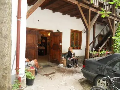 a group of people sitting in a house at Hostel Mostel Sofia in Sofia