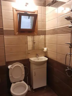 a bathroom with a toilet and a sink at Mario Complex in Melnik