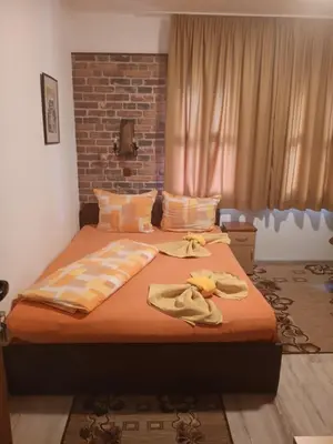 a bedroom with a large bed with towels on it at Mario Complex in Melnik