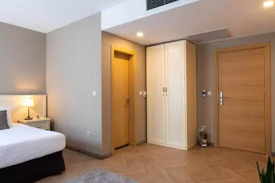 a bedroom with a bed and two closets in it at St. George Hotel in Sofia