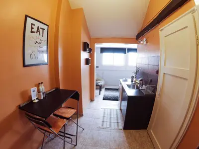 a kitchen with a sink and a table and chairs at Studio 5 Corners in Sofia