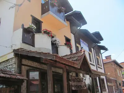 a building with flower boxes on top of it at Старата Тонина къща in Dobrinishte