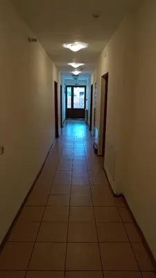 an empty hallway with a tile floor in a building at Medic Hotel in Sofia