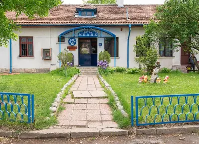 a house with a blue fence in front of it at Medic Hotel in Sofia