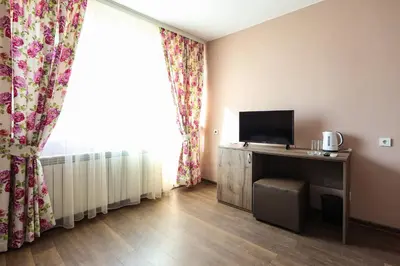 a room with a desk with a television and a window at The Secret Garden in Ognyanovo