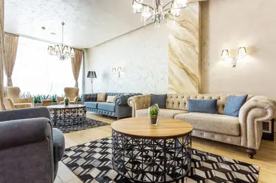 a living room with couches and a table at City Avenue Hotel in Sofia