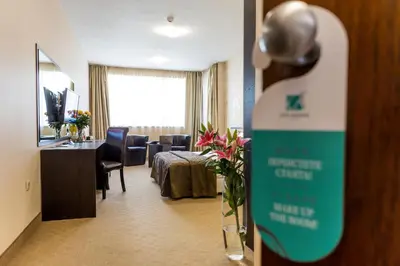 a hotel room with a sign on a door at City Avenue Hotel in Sofia