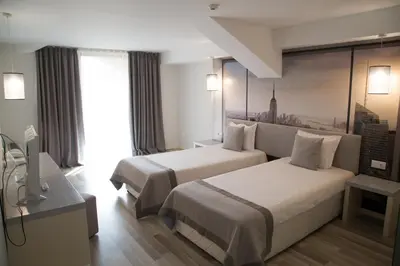 a hotel room with two beds and a window at Tsarsko Selo Spa Hotel in Sofia