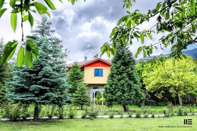 a house with trees in front of it at Tsarsko Selo Spa Hotel in Sofia