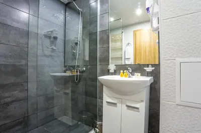 a bathroom with a sink and a shower at Park Hotel Asarel in Panagyurishte