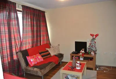 a living room with a couch and a christmas tree at Feels like Home 