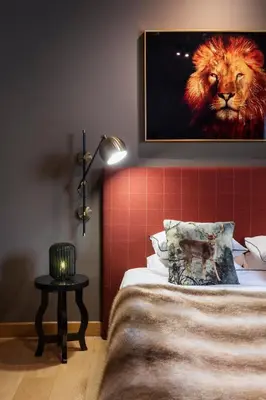 a bedroom with a bed with a lion painting on the wall at Borovets Chalets in Borovets