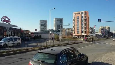 a car driving down a street in a city at Apartments Mladost 1A in Sofia