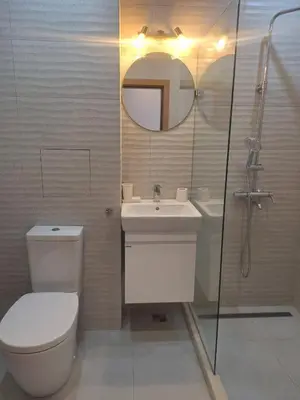 a bathroom with a toilet and a sink and a mirror at Apartments Mladost 1A in Sofia