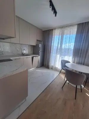 a kitchen with a table and a table and chairs at Apartments Mladost 1A in Sofia